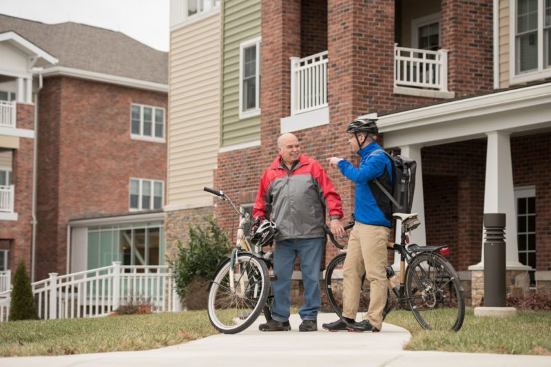 two men talking by their bikes