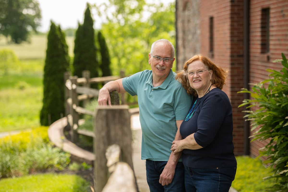 three seniors holding books and talking